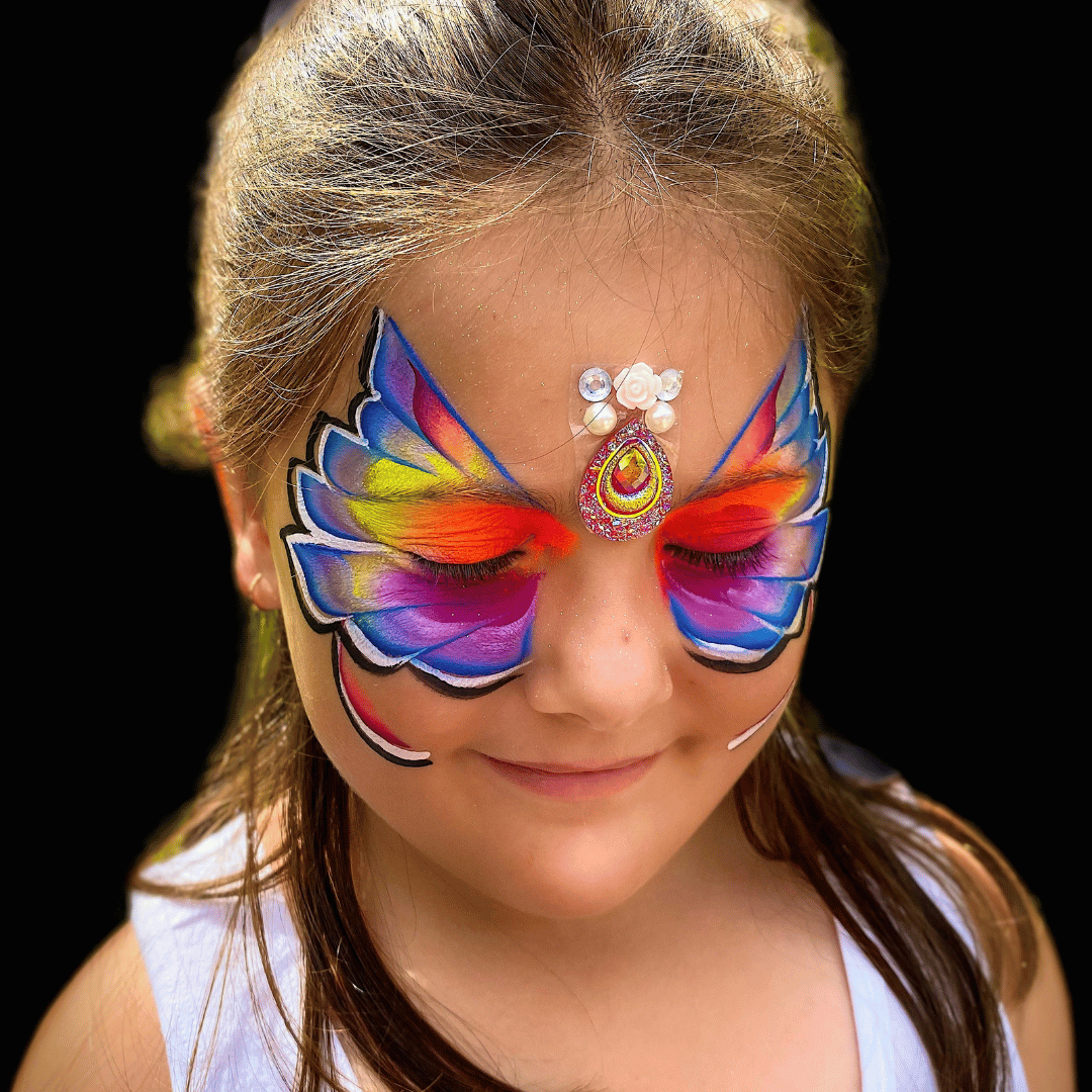 A stunning butterfly face paint design, bursting with a kaleidoscope of vibrant and captivating colours