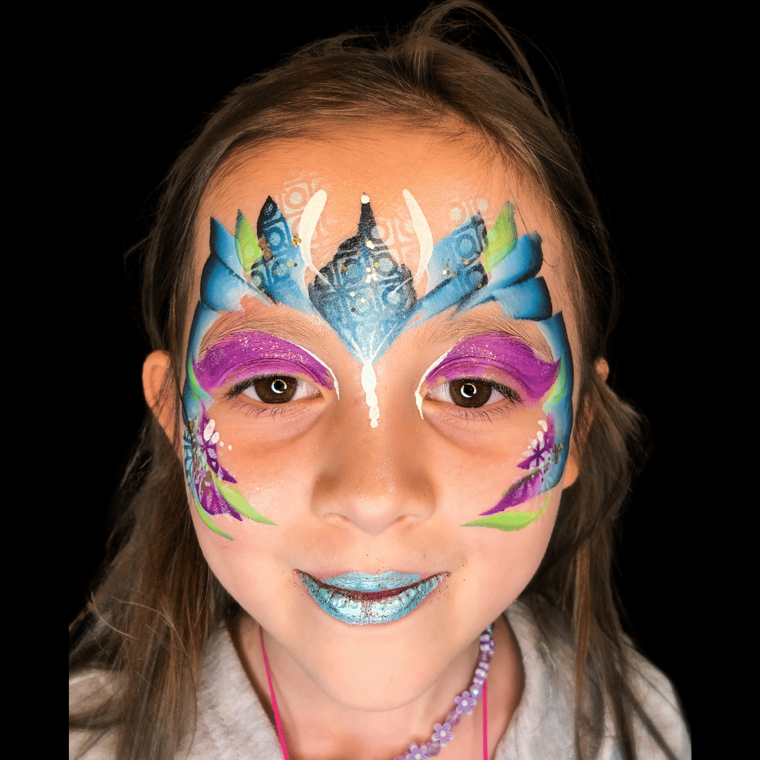 Stunning mermaid-inspired face paint in shades of green and blue, evoking the allure and enchantment of underwater realms, as our staff members embrace their inner mermaids with style and grace